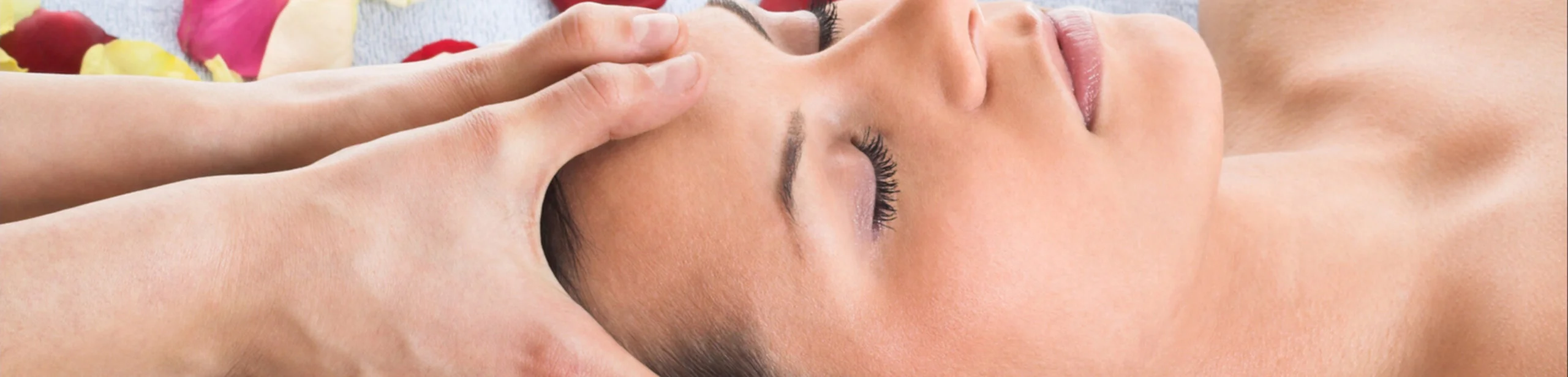 Das Bild zeigt eine weibliche Person bei der Massage des Kopfes